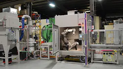 The Guyson RB10TC robotic gritblast system with a precision transfer cart to carry pallets of turbine blades in and out of the blasting chamber where each component is grasped and exposed to the media stream from a single blast gun according to a programmed processing routine