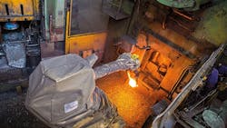 A Comau robot positions the glowing semifinished workpiece in the forming die for San Grato SpA A Comau robot positions the glowing semifinished workpiece in the forming die for San Grato SpA