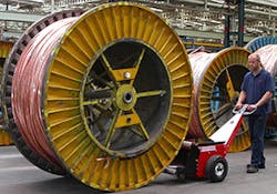 Worker Pushing a 9-ton Cable Drum Worker Pushing a 9-ton Cable Drum