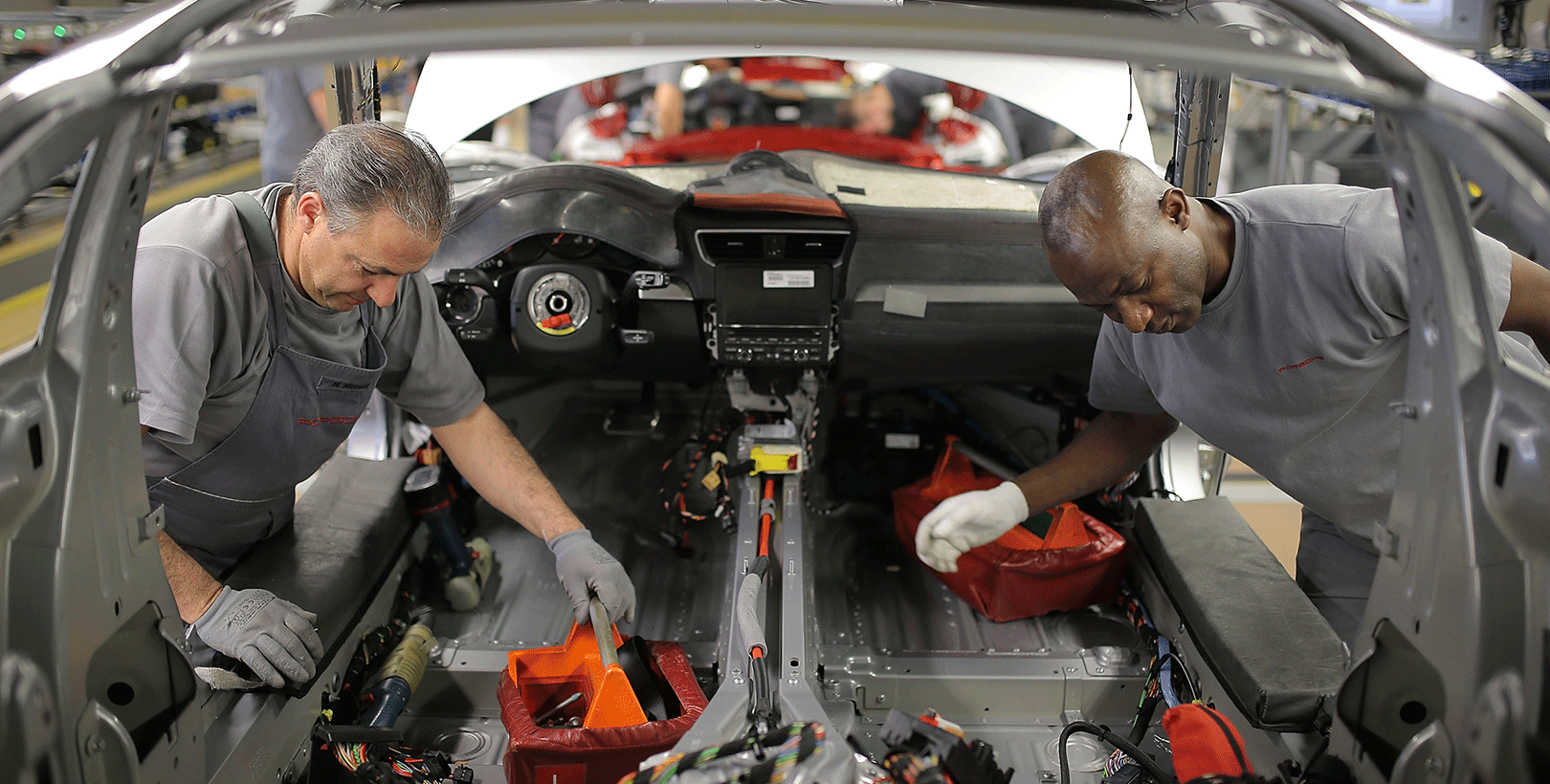 Workers assemble a sports car