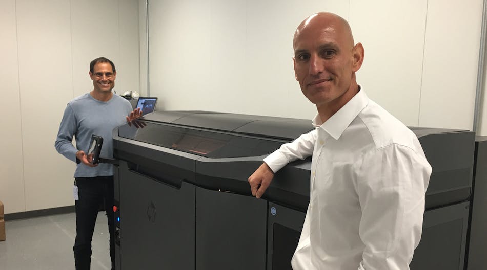 Jabil Circuit COO Bill Muir, right, and John Dulchinos, VP, Global Automation and 3-D Printing, show off the first installation of the HP Jet Fusion Printer, which 3-D prints 10 times faster than any other current machines.