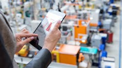 Woman working on tablet in factory Woman working on tablet in factory