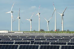 Solar panels and wind turbines in field Solar panels and wind turbines in field
