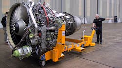 Worker pushing airplane propeller Worker pushing airplane propeller