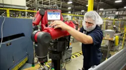 Worker using Baxter collaborative robot