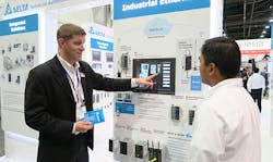 Bill Faber, Delta's Industrial Automation Team Leader, shows a PACK EXPO 2017 visitor the company's latest in automated equipment solutions. Bill Faber, Delta's Industrial Automation Team Leader, shows a PACK EXPO 2017 visitor the company's latest in automated equipment solutions.