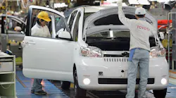 Toyota factory workers on assembly line