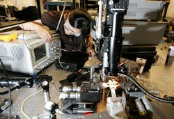 Woman-Testing-Electronics Woman-Testing-Electronics