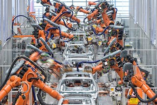 Kuka Systems robots assembling cars at an Audi plant.