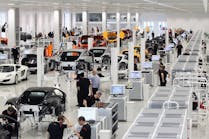 Workers assemble high performance McLaren MP4-12C sports cars
