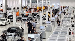 Workers assemble high performance McLaren MP4-12C sports cars Workers assemble high performance McLaren MP4-12C sports cars