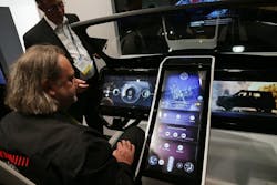 Man inspects connected car console on display Man inspects connected car console on display