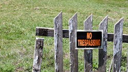 No trespassing sign on wooden fence No trespassing sign on wooden fence