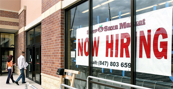 Now hiring sign in store window