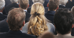 Woman sitting in crowd of men Woman sitting in crowd of men
