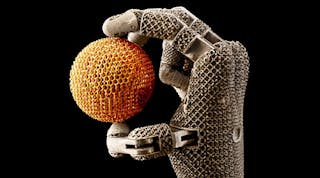 Metal mesh hand holding metal mesh ball