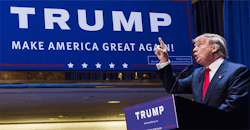 Donald Trump pointing up in front of campaign sign Donald Trump pointing up in front of campaign sign