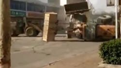 Front loader on side in street Front loader on side in street