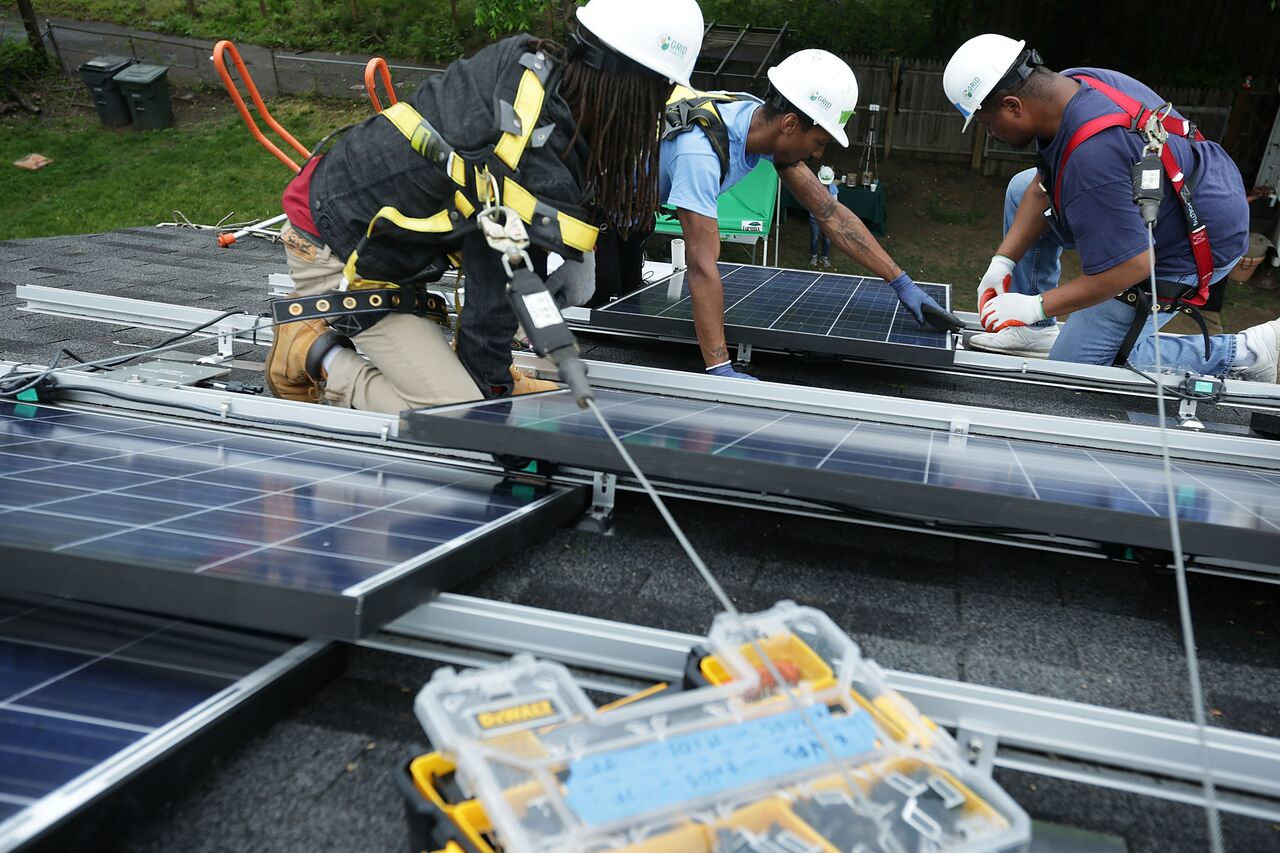 Men installing solar panels