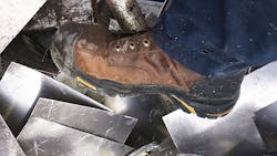 Keen work boots stepping on metal scraps Keen work boots stepping on metal scraps