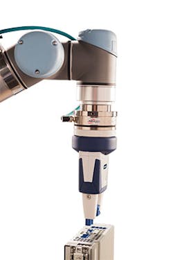 The Axia80 wedged in between a cobot and parallel grippers to enhance accuracy.
