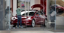 Red Tesla Model 3 in showroom Red Tesla Model 3 in showroom