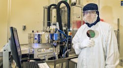 Process Engineer Richard Kasica of NIST&rsquo;s Center for Nanoscale Science and Technology holds a wafer of the type typically produced in the plasma-enhanced chemical vapor deposition chamber.