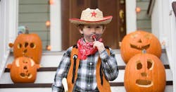 Cowboy kid with lollipop on Halloween