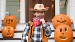 Cowboy kid with lollipop on Halloween Cowboy kid with lollipop on Halloween