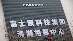 The Hon Hai / Foxconn wordmark on the exterior of a building. The Hon Hai / Foxconn wordmark on the exterior of a building.