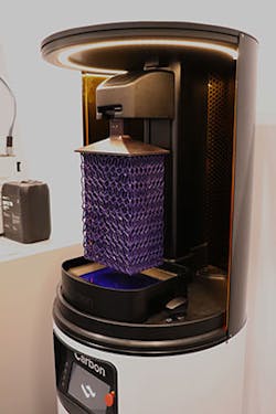 Carbon uses digital light synthesis to quickly manifest complex industrial-grade parts, such as the lattice structure above, from the liquid resin bed.