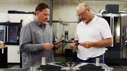 Allegiance Mold President and CEO Ted Stender and senior mold designer Dave VanDeLaare inspecting final parts from plastic injection mold designed and manufactured using Cimatron