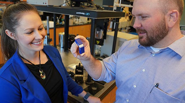 Travis Walker, Ph.D., holds an example of a 3D printed item made with two different materials. He and Katrina Donovan, Ph.D., say this object is a large-scale example of the kind of 3D printed materials now possible at scales smaller than a human hair.