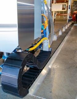 US AutoCure has 2 systems. The Phoenix has 13 axes of motion, while The Eagle has 11. The energy chains protect lines from pinching and heat sources without limiting the motion of multiple axes. US AutoCure has 2 systems. The Phoenix has 13 axes of motion, while The Eagle has 11. The energy chains protect lines from pinching and heat sources without limiting the motion of multiple axes.