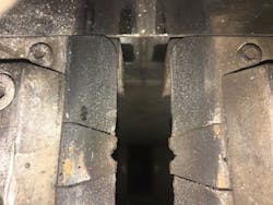 Fig. 4: The view from above the gripper fingers. The copper electrode inserts can be seen as well as the deposits of weld splatter and contamination. Fig. 4: The view from above the gripper fingers. The copper electrode inserts can be seen as well as the deposits of weld splatter and contamination.