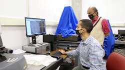 Purdue University engineers Anirudh Udupa (seated) and Srinivasan Chandrasekar (standing) analyze metal surfaces to look for deformations created during cutting to determine how applied materials affect the quality of the cut.
