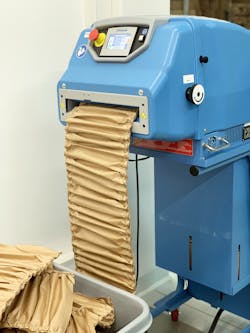 Packaging machine produces flexible, environmentally friendly filler from paper. Packaging machine produces flexible, environmentally friendly filler from paper.