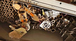 The robotic arm moves the soil samples to the volume assessment and scanning stations, then to the sealing station, and finally into temporary storage—all autonomously. The robotic arm moves the soil samples to the volume assessment and scanning stations, then to the sealing station, and finally into temporary storage—all autonomously.