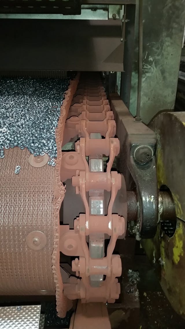 Nuts And Bolts On Conveyor Belt