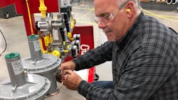 Worker checking valve train Worker checking valve train