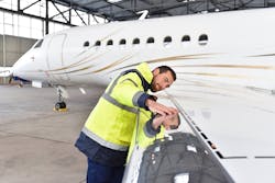 Man Checking Airplane Wing Man Checking Airplane Wing