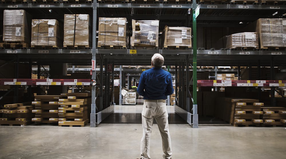 Man Looking at Inventory at Warehouse