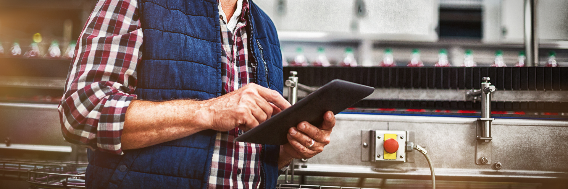 Man worker on tablet at factory