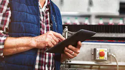 Man worker on tablet at factory