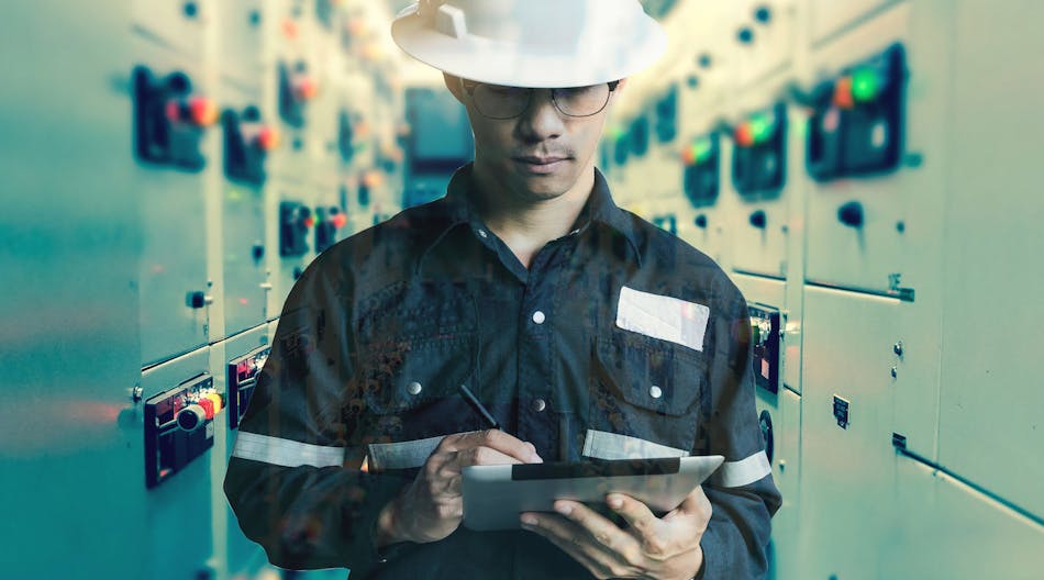 Worker Maintaining Equipment With Tablet