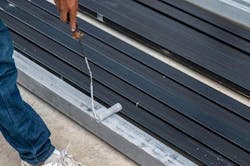 Worker using Cortec's VpCI-395 to coat beams. Worker using Cortec's VpCI-395 to coat beams.