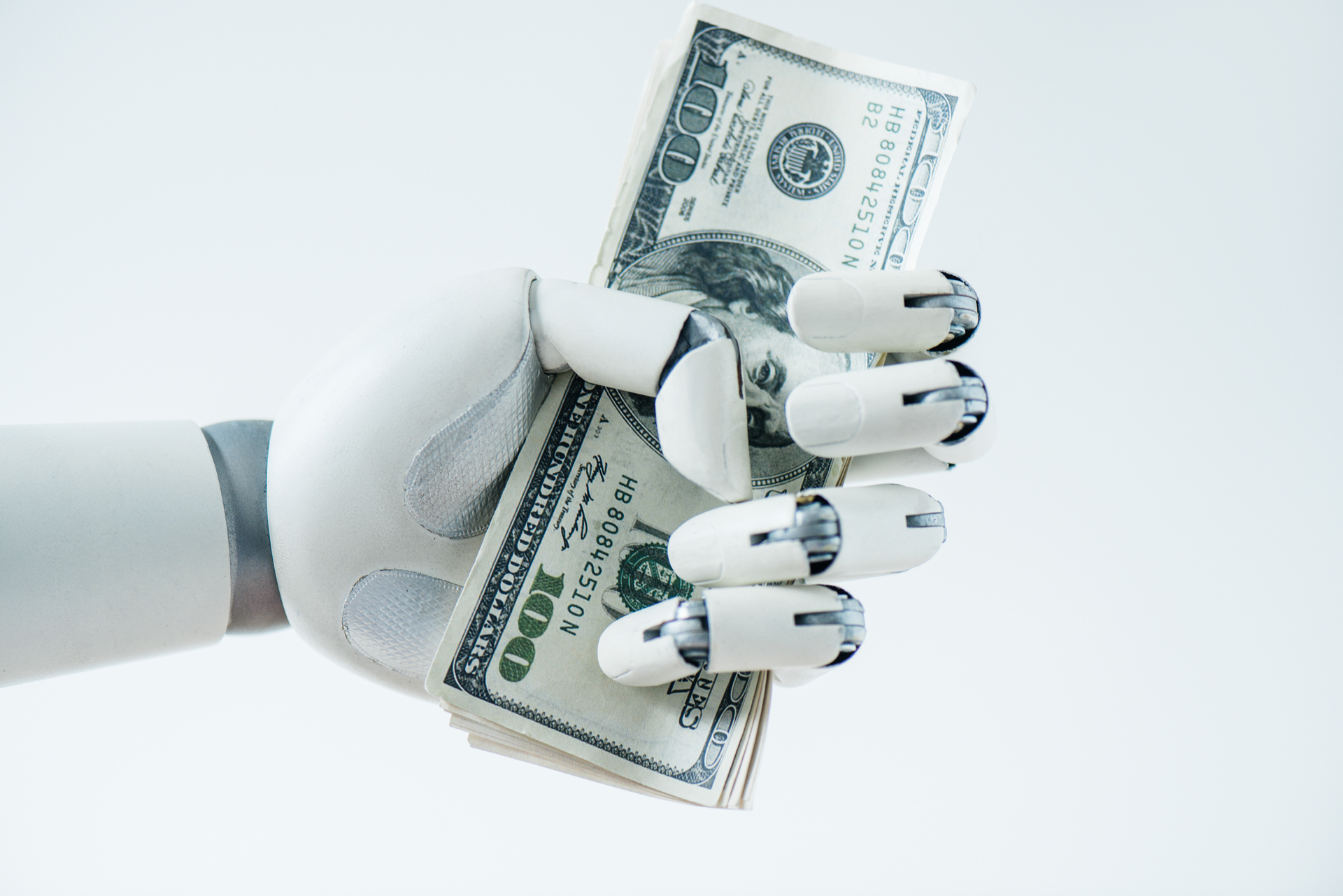 close-up view of robot holding dollar banknotes