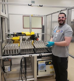 An operator loading raw stock into the storage tray. An operator loading raw stock into the storage tray.