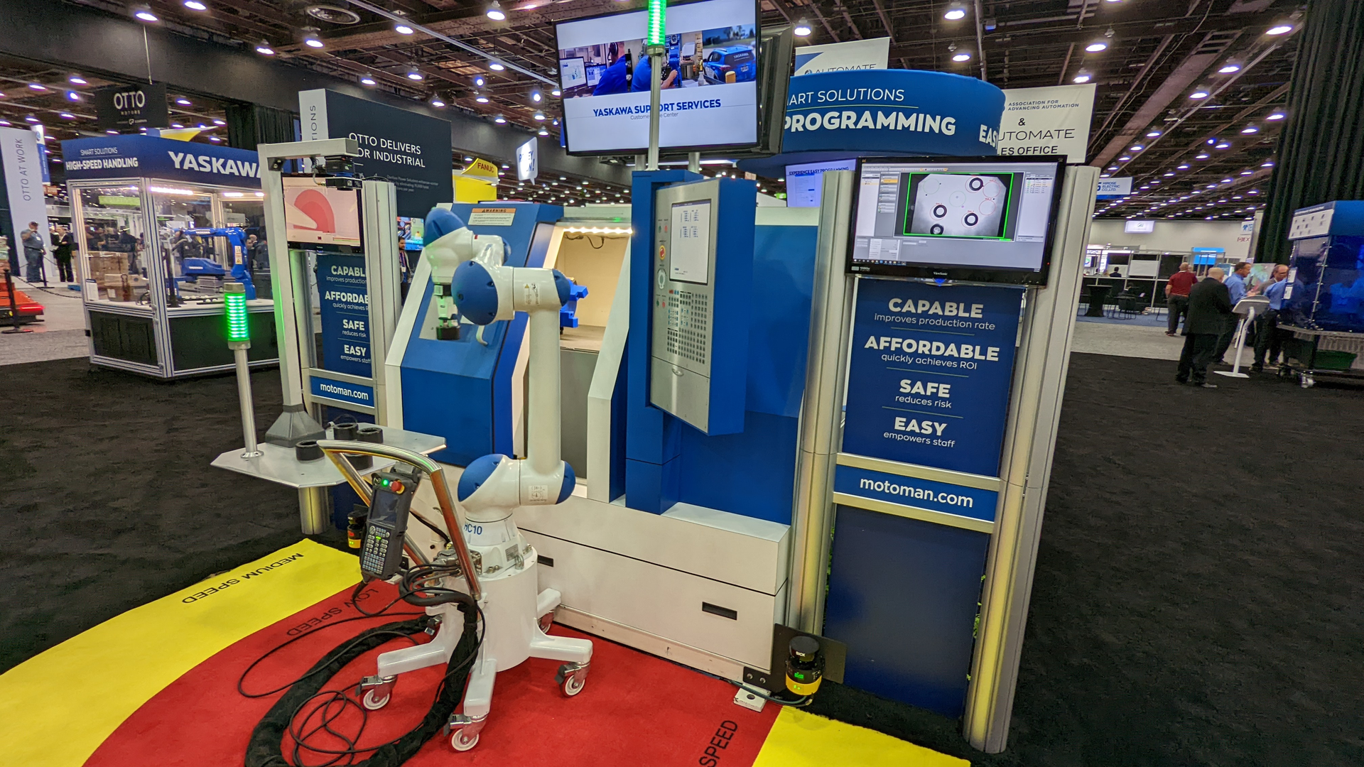 A mobile robot autonomously manages a machine tool at Yaskawa's booth at the AUTOMATE trade show in Detroit, MI.
