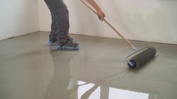 Worker Applying Coating to Floor Worker Applying Coating to Floor